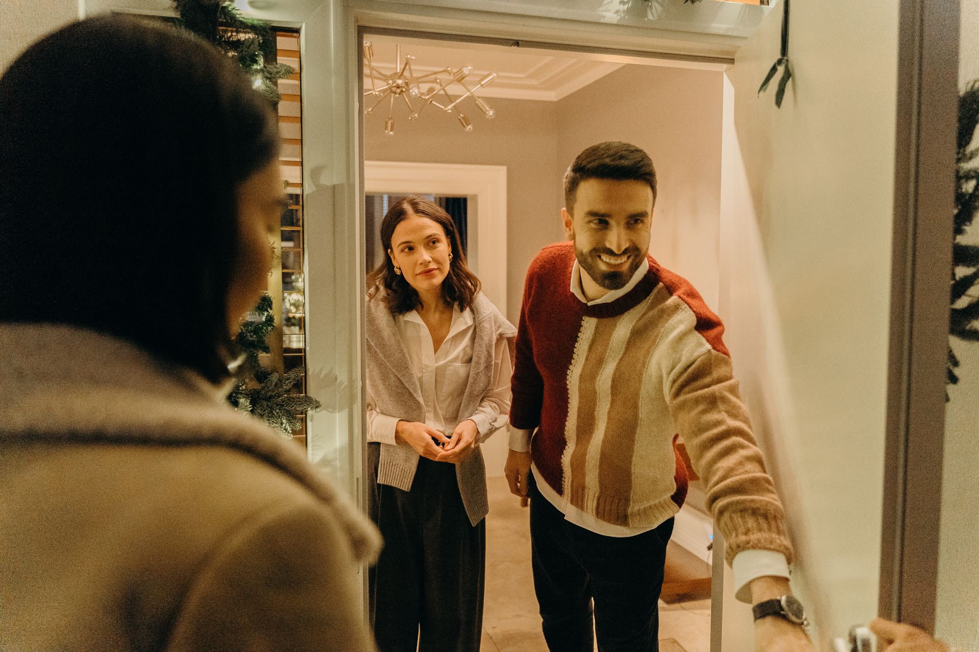 Ystävät tulevat kyläilemään ja isäntäväki avaa oven. Kuva: Cottonbro/Pexels