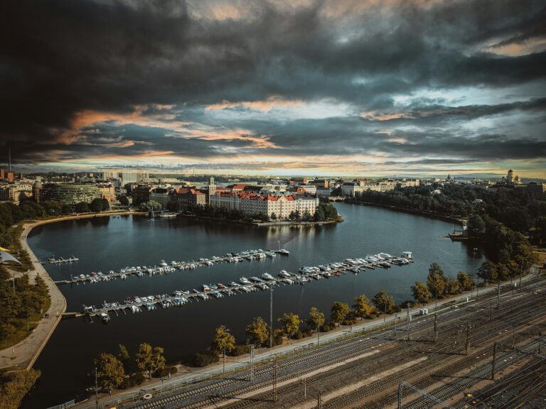 Ilmakuva Helsingin Töölönlahdesta, jonka ympärillä näkyy rakennuksia, puita, venesatama ja rautatiekiskoja.